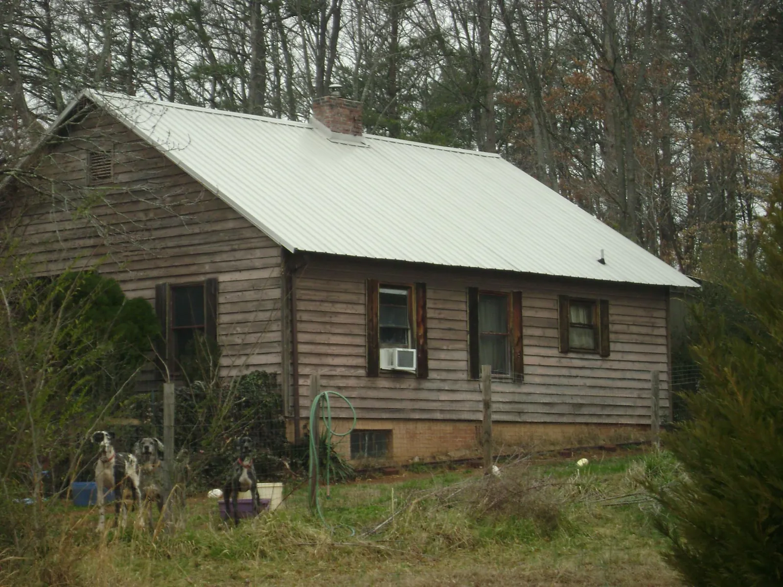 White metal roof on an old wood sided farmhouse, from a Metal Roof Installation job in Saint Paris